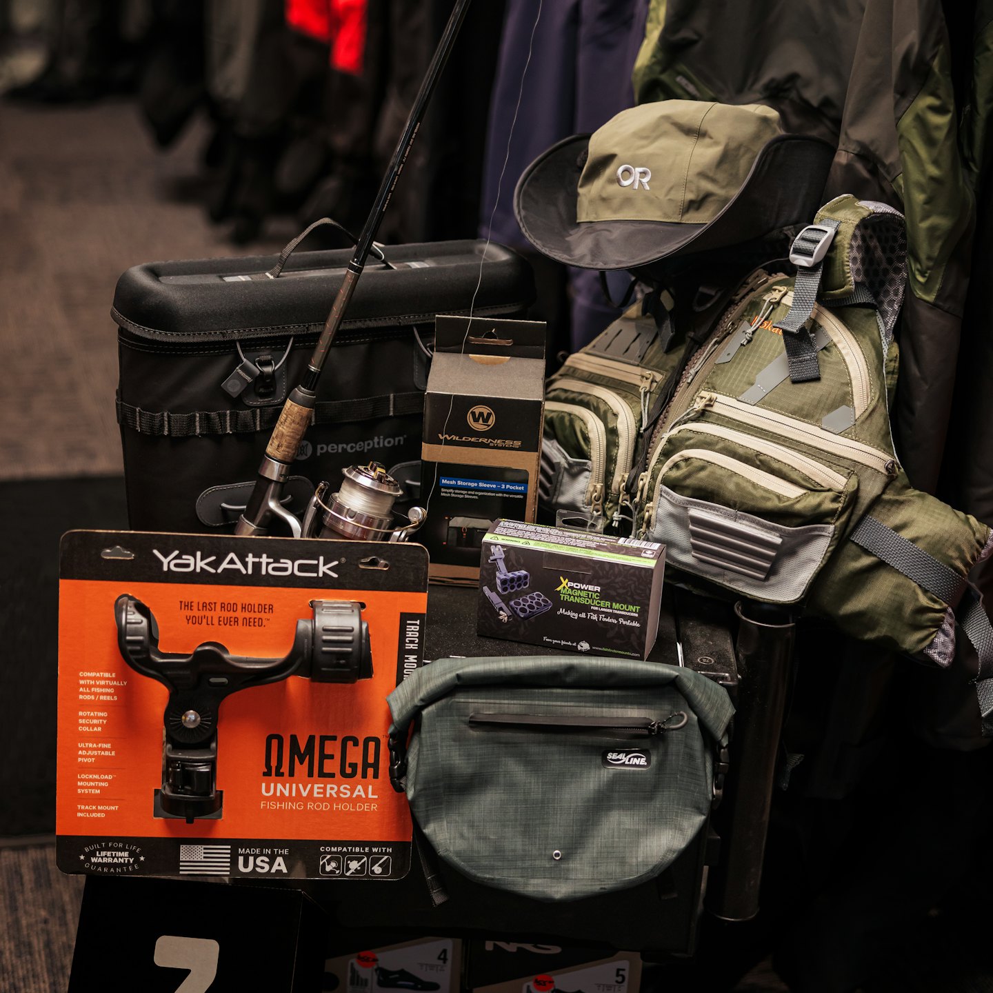 Fishing gear including rod, reel, vest, hat, and cooler.